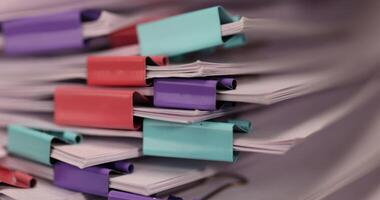 stacked sheets of paper for documents are joined together, paper is different in each clip photo