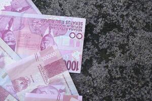 Indonesian money is neatly lined up with various denominations. photo