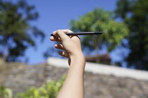 the concept of education by holding a pen photo