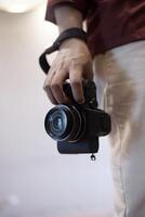 close up photographer holding camera with right hand photo