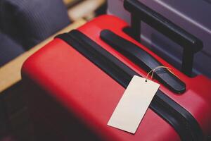 Red Suitcase with Blank Luggage Tag. Journeys, holidays, business trips, and new adventures. Perfect for travel agencies, booking platforms, or articles about packing and travel preparation. photo