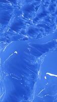 Abstract glossy blue surface resembling liquid or ice textures with smooth, shiny reflections video