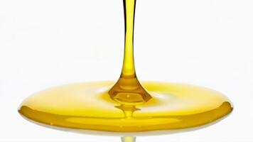 Fresh olive oil dripping and pooling on an isolated white background. Useful for food, cooking, and healthy eating concepts. photo
