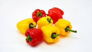 Yellow and red mini bell peppers isolated on a white background. Suitable for food, nutrition, and healthy eating concepts. photo