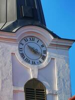 A clock on a building photo