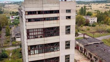 Tall building with broken windows and roof. Exterior of an old abandoned building on empty manufacturing. Damaged house. video