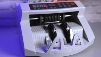 a cash count machine counts US 100 dollar bills video