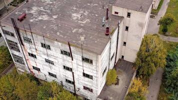 Old factory. Abandoned buildings and warehouses with broken windows after the war. Empty industrial plant. View from above. video