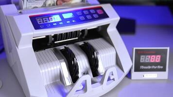 Modern electronic machine. Machine counter automatically calculates a large amount of dollar banknotes. Top view. Business accounting. video