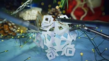 Robotic tool cutting paper snowflake. Smart robot making Christmas decorations. Modern intelligent equipment preparing for New Year. video