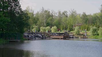 A Serene Lakeside View featuring Lush Greenery Enhanced by Beautiful, Tranquil Waterfalls video