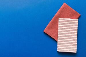 top view with red empty kitchen napkin isolated on table background. Folded cloth for mockupce photo