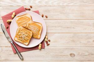 Peanut butter sandwiches toasts on light table background. Vegetarian food. American cuisine photo