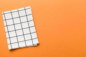 top view with white empty kitchen napkin isolated on table background. Folded cloth mockup with copy space, photo