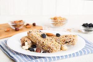 Various granola bars on table. Cereal granola bars. Superfood breakfast bars with oats, nuts and berries, close up. Superfood concept photo