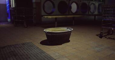 Cinematic CGI Empty bucket in a dimly lit laundromat during late night hours video