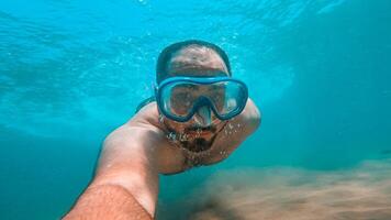 Man diving in water with a mask photo