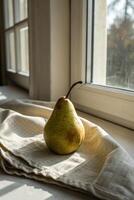 Pear Still Life, Green Pear on Linen by Window Light photo