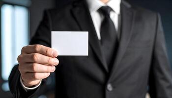 Close Up of Businessman in Formal Suit Presenting Blank White Business Card for Networking photo