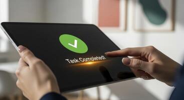 Woman hands interacting with tablet displaying green checkmark for task completion photo