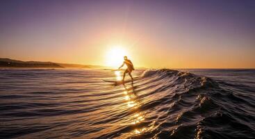 Lone surfer riding ocean wave at golden sunset with sun flare and horizon photo