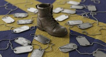 Worn combat boot and tarnished military dog tags on faded fabric photo