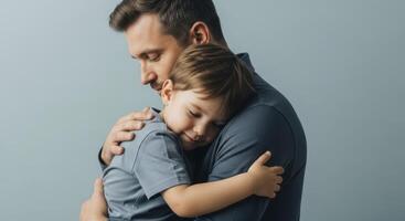Tender close up of a father embracing his young son, showing love and comfort. photo