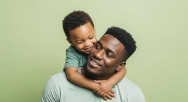 Joyful african american father and son hugging with love in studio portrait photo
