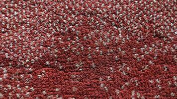 Intricate Red and Beige Textured Carpet Closeup - A Detailed Macro Shot Revealing the Woven Fibers and Pattern. photo