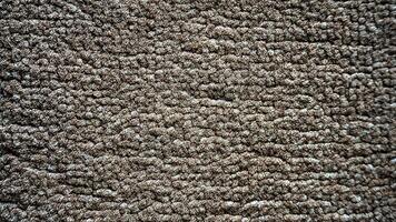 A close up of a carpet with a brown color photo