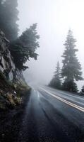 Serene drive along a winding mountain road enveloped in a mystical fog offering breathtaking views amid nature's embrace scenic and unforgettable photo