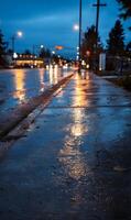 Reflections on a wet urban sidewalk after rain at twilight creating a calming atmosphere with city photo