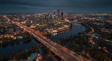 Nighttime cityscape of Warsaw Poland featuring a modern skyline illuminated bridges and flowing river photo