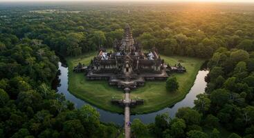 Breathtaking aerial vista of Angkor Wat temple at sunrise surrounded by lush jungle and serene moat in Cambodia photo