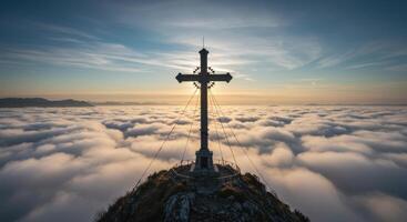 Majestic summit cross stands tall above ethereal clouds during sunrise in the Alps offering a spiritual scenic view photo