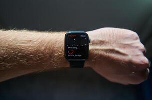 A square smartwatch on a man's hand close up. Heart rate measurement on watch photo