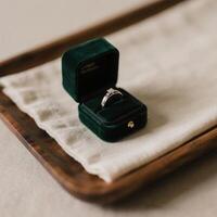 A wedding ring in a velvet box on a table photo