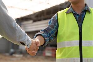 team hands shaking greeting start up plan new project contract in office center at construction site, industry ,architecture, partner, teamwork, agreement, property, photo