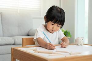 Happy Asia child play and learn drawing picture and cartoon. Funny family is happy and excited in the house. Mother and daughter having fun spending time together. Holiday, Activity. photo