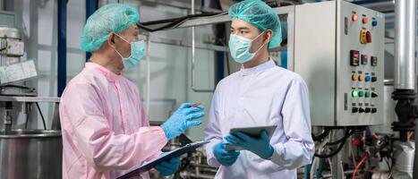 quality supervisor or food or pharmaceutical technician discuss about process control of food and drugs before send product to the customer. Production leader recheck parameter and productivity. photo