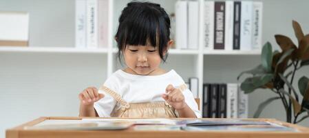 children read book at home. daughter and reading a story. learn development, childcare, laughing, education, storytelling, practice, imagine, reduce addiction mobile phone. photo
