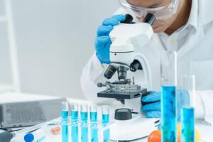 Scientist analyze biochemical samples in advanced scientific laboratory. Medical professional use microscope look microbiological developmental of viral, Biotechnology research photo