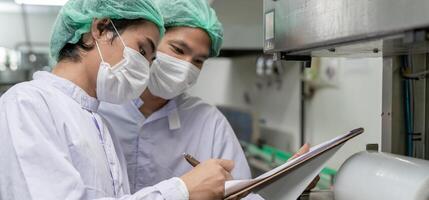 Inspector of food or beverages inspection about quality control food or beverages on warehouse before send product to the customer. Quality control or assurance. photo