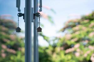 key for unlocking house is plugged into the door. Second hand house for rent and sale. keychain is blowing in the wind. mortgage for new home, buy, sell, renovate, investment, owner. photo