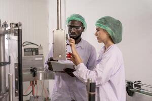 supervisor food or beverages technician inspection about quality control food or beverages before send product to the customer. Production leader recheck ingredient and productivity photo