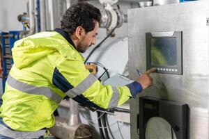 Engineers or factory managers wearing safety helmet inspect the machines in the production line. Utility inspector check machine and test the system to meet the standard. machine, maintenance photo