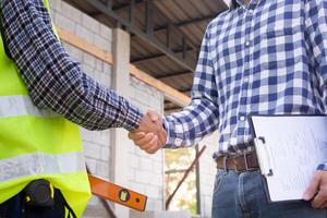 Construction team hands shaking greeting start up plan new project contract in office center at construction site, industry ,architecture, partner, teamwork, agreement, property contacts photo