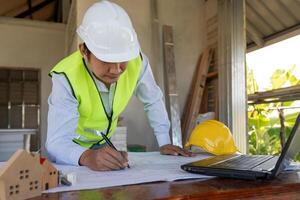 engineer construction and quality assurance new house using a blue print. Engineer or architects or contactor work to build the house before handing it over to the homeowner photo