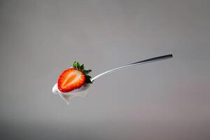 A spoon with a strawberry on it photo