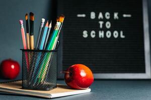 Back to School Concept with Blackboard, Pencils and Apples photo